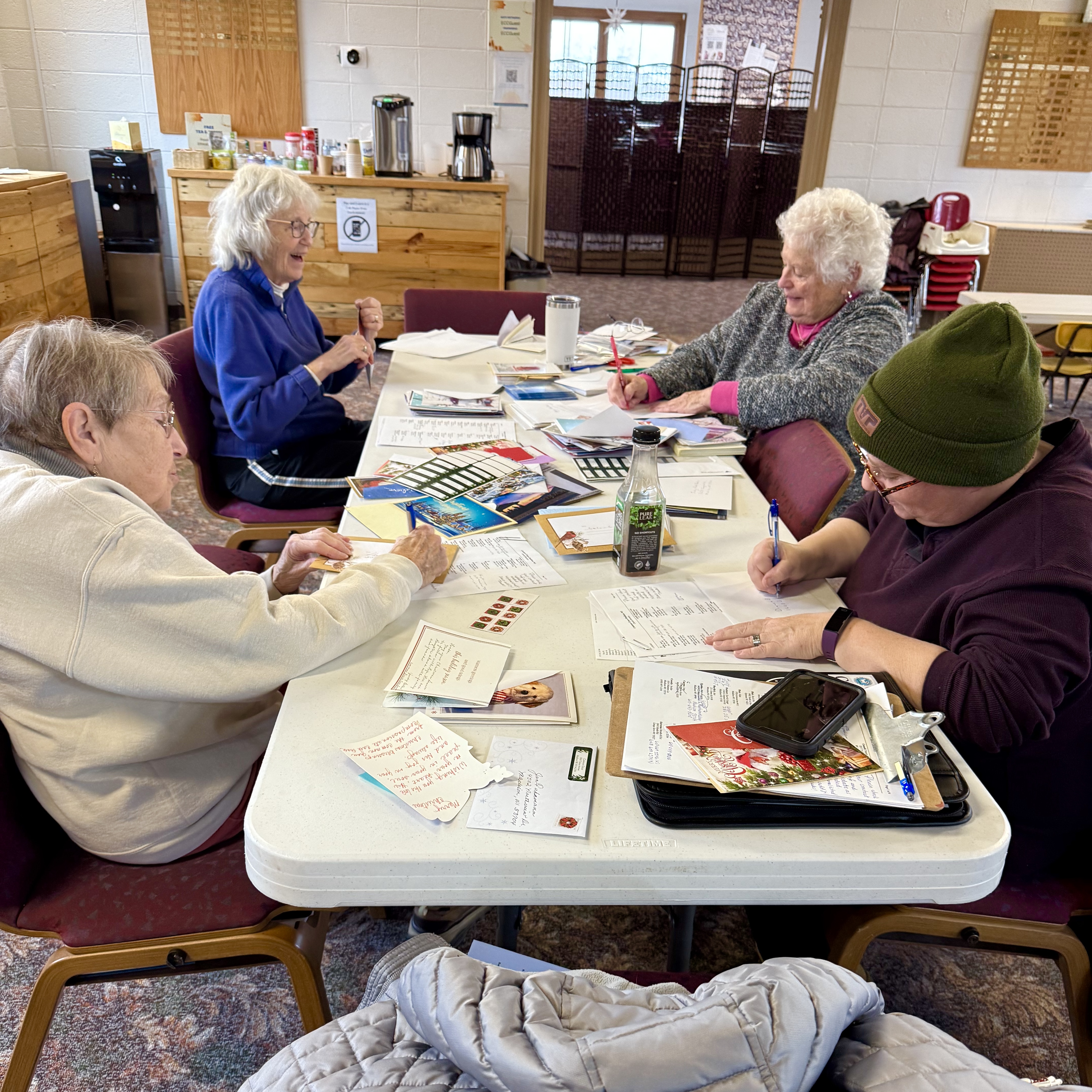 Four women working together around a table