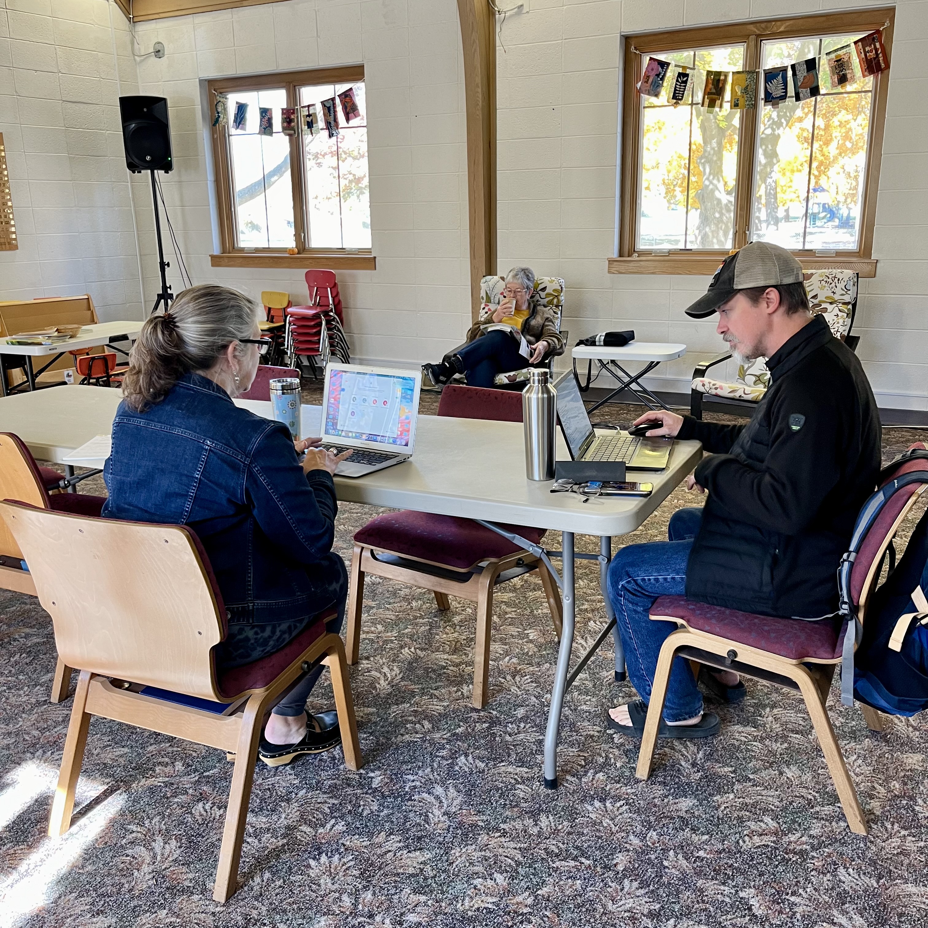 Neighbors working and talking together around a shared table